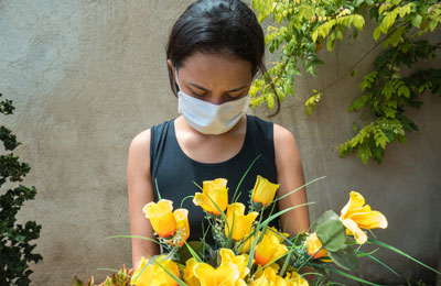 Woman with mask and flowers